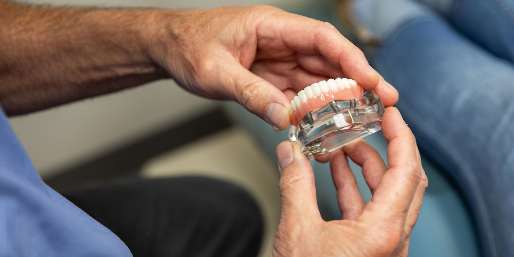 Dentist hold Dental Implants Model